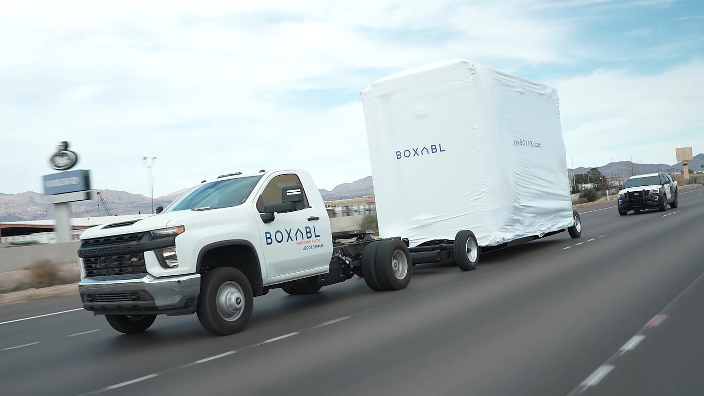 A BOXABL truck hauling a folded Casita unit down a Nevada highway